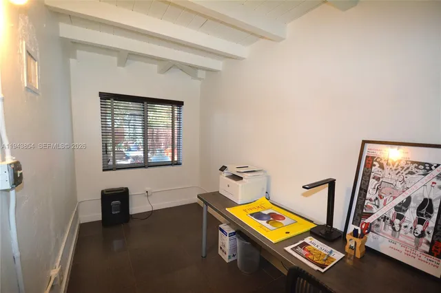 a view of a house with a tree in the forest