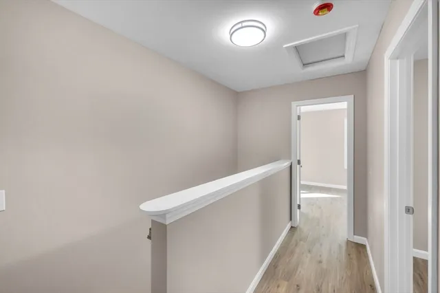 a view of hallway with wooden floor