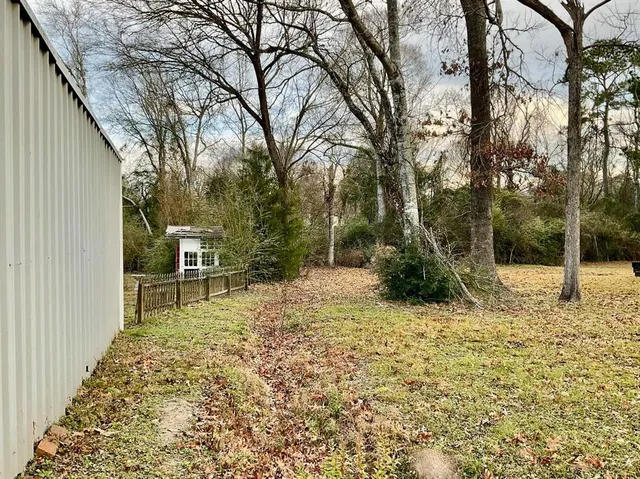 a backyard of a house with table and chairs
