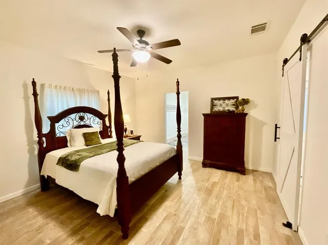 a bedroom with bed and a dresser