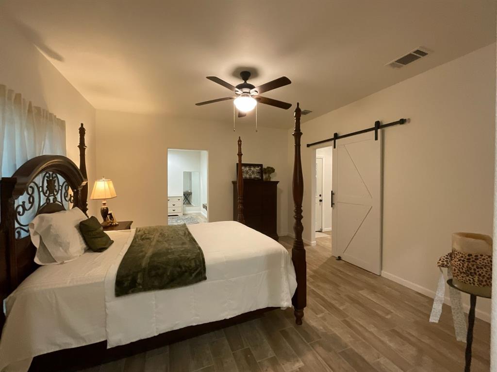 544 Keathley Road Lufkin, TX 75904 - Photo 8 of 15 a bedroom with a bed and a chandelier