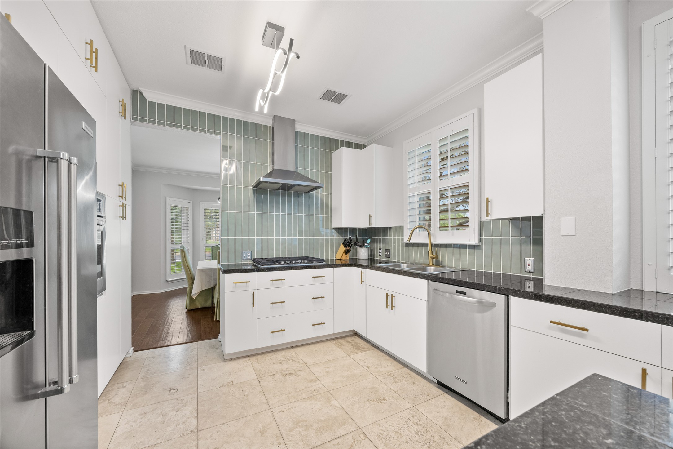 8610 Axis Drive Austin, TX 78749 - Photo 5 of 29 a large kitchen with stainless steel appliances granite countertop a sink and dishwasher a refrigerator with wooden floor