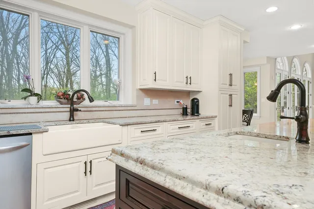a kitchen with stainless steel appliances granite countertop a stove and a sink