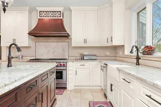 a large white kitchen with a large counter top and appliances