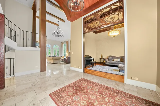 a living room with fireplace furniture and a large window