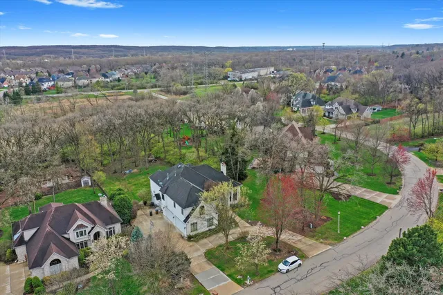 an aerial view of a house with a garden and trees