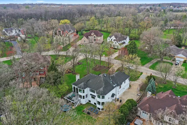 a view of a deck with couches table and chairs and wooden floor