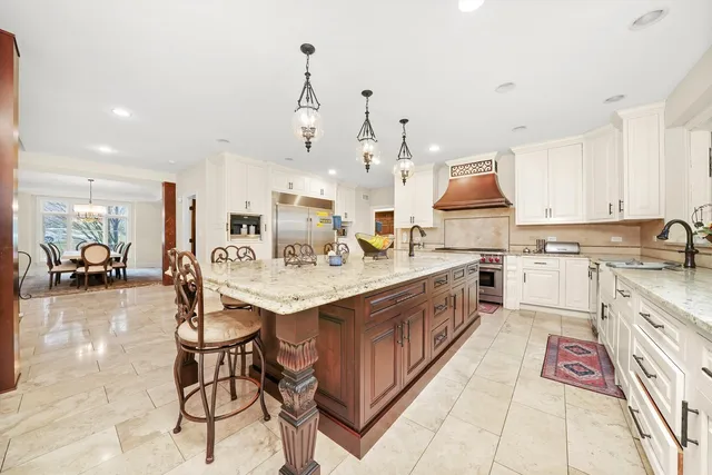 a kitchen with stainless steel appliances a sink stove and cabinets