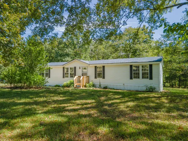 a view of a house with yard and a garden