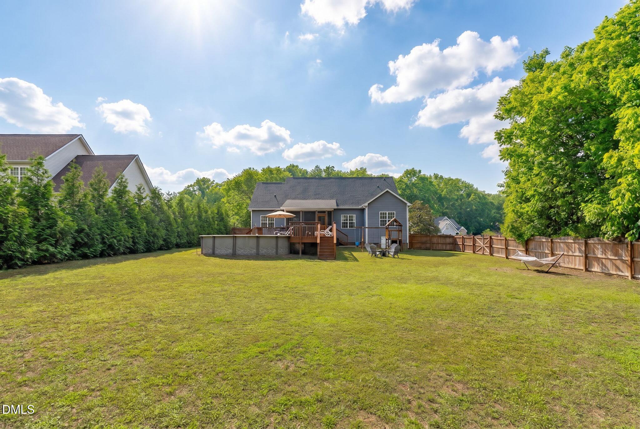 2450 Rolling Tracks Road Willow Spring, NC 27592 - Photo 55 of 64 a view of a house with a big yard