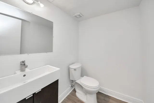 a bathroom with a sink toilet vanity and tub