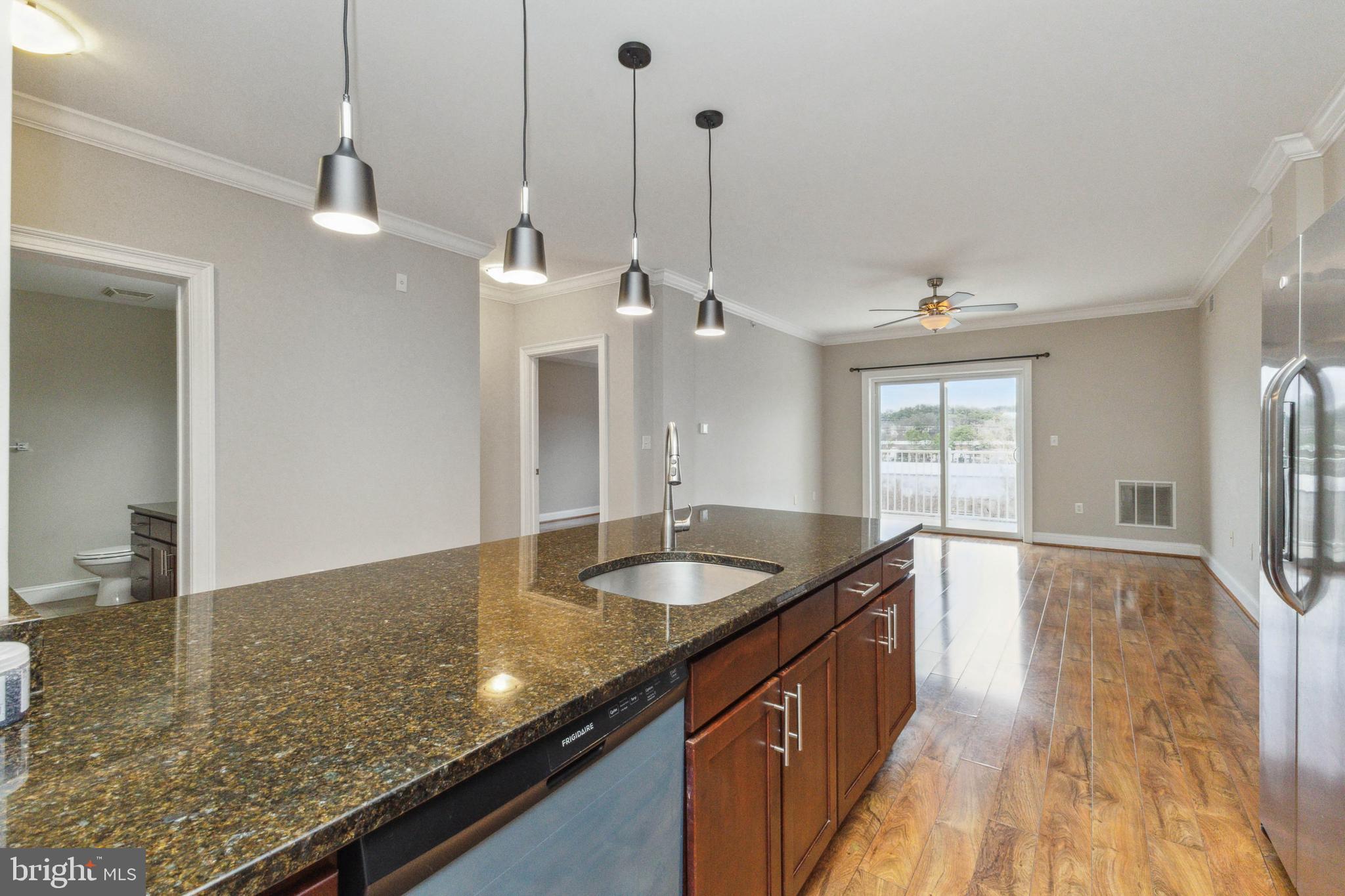 6301 Edsall Road, Unit 513 Alexandria, VA 22312 - Photo 22 of 38 a kitchen with granite countertop a sink a counter space and wooden floor