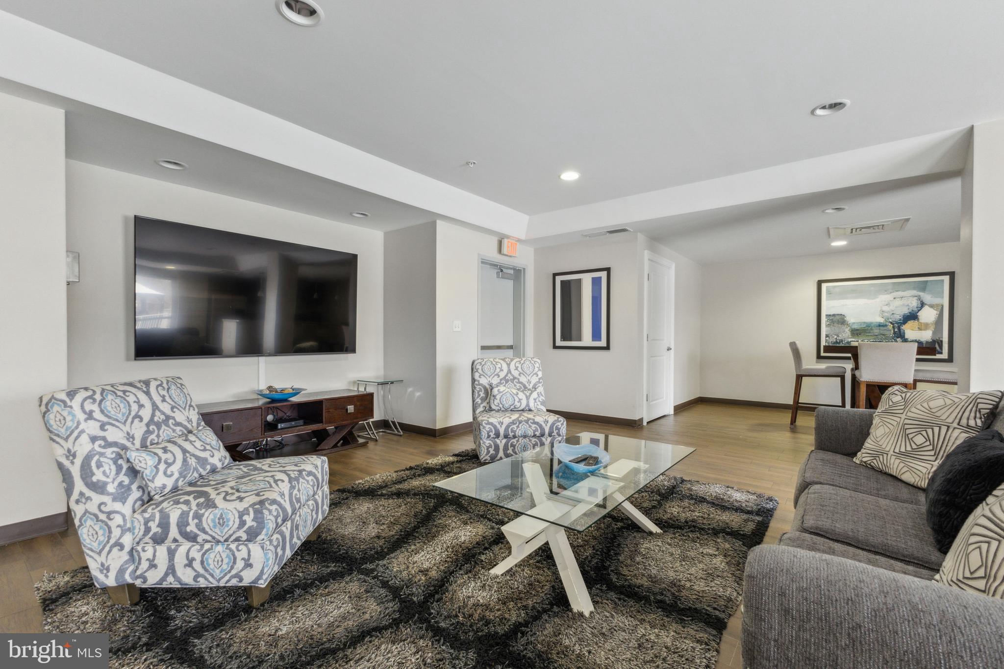 6301 Edsall Road, Unit 513 Alexandria, VA 22312 - Photo 7 of 38 a living room with furniture and a flat screen tv