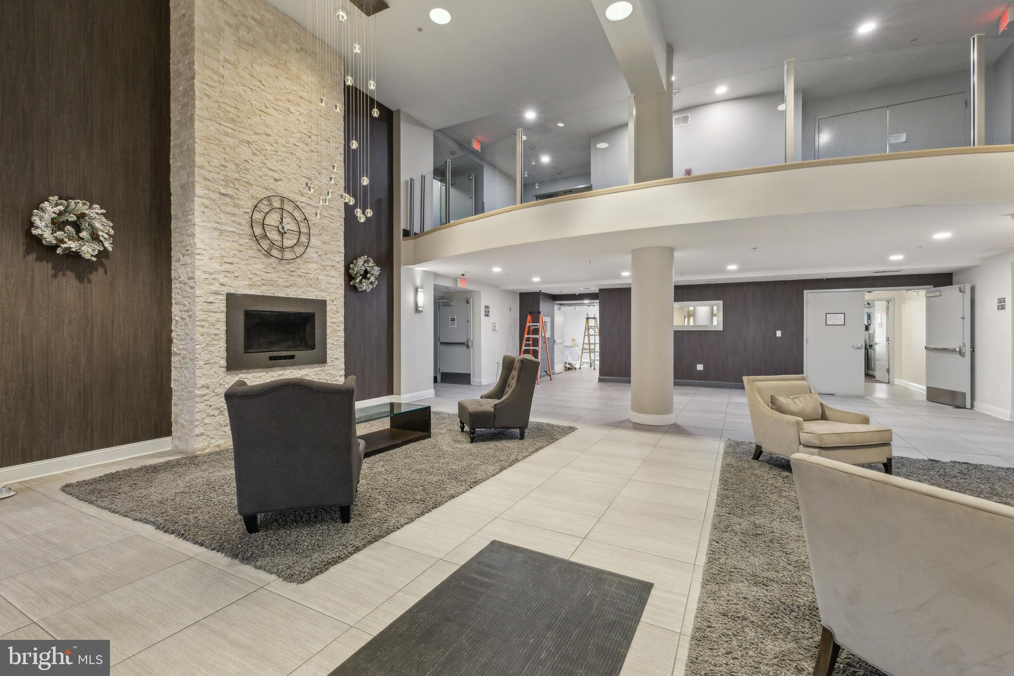 6301 Edsall Road, Unit 513 Alexandria, VA 22312 - Photo 8 of 38 a lobby with furniture and a fireplace