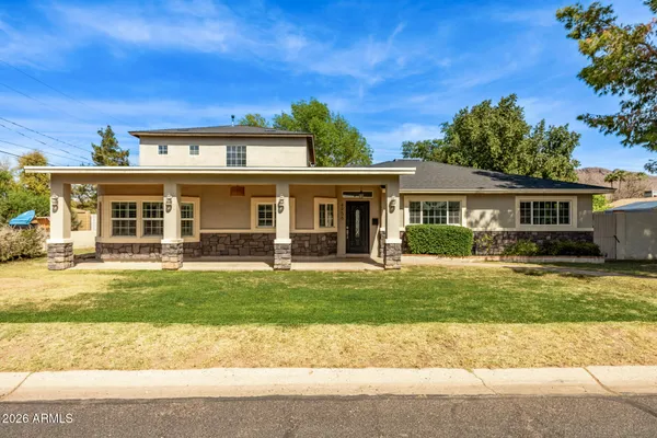 a front view of a house with a garden