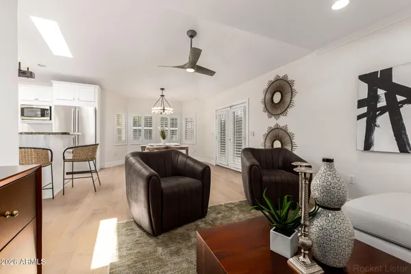 a kitchen with stainless steel appliances granite countertop a sink a stove a refrigerator cabinets and dining table