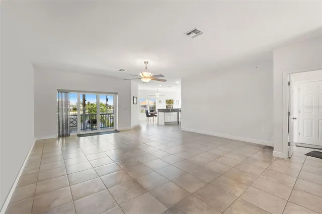 a kitchen with stainless steel appliances granite countertop a refrigerator a stove a sink a table and chairs