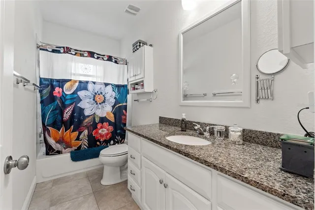 a view of a backyard with plants and patio