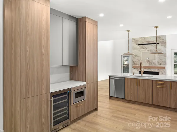 a kitchen with stainless steel appliances a refrigerator and a sink