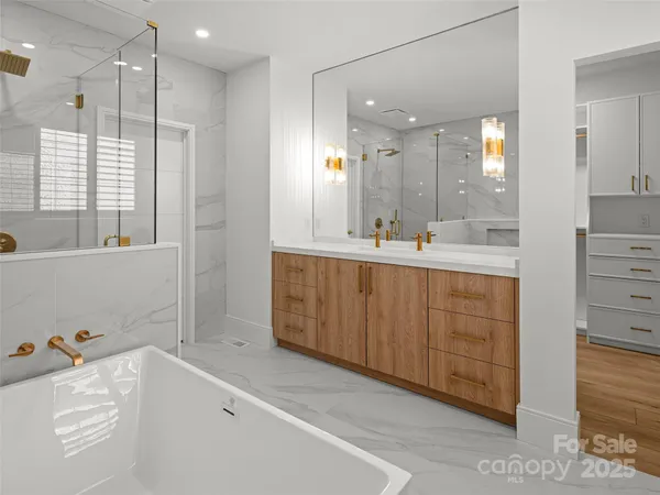 a bathroom with a tub sink and mirror