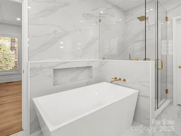a bathroom with a bathtub and a shower