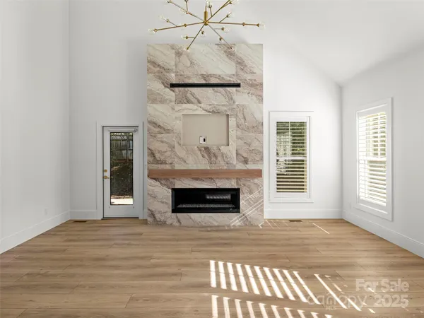 a view of a livingroom with a fireplace and window