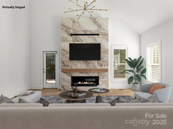 a living room with furniture a fireplace and a flat screen tv