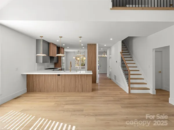 a view of kitchen with wooden floor and electronic appliances