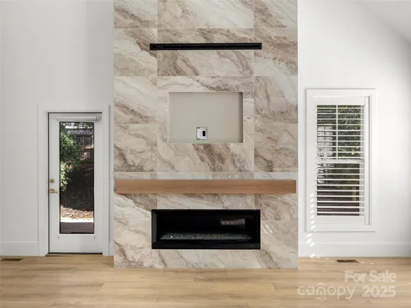 a view of a livingroom with a fireplace and window