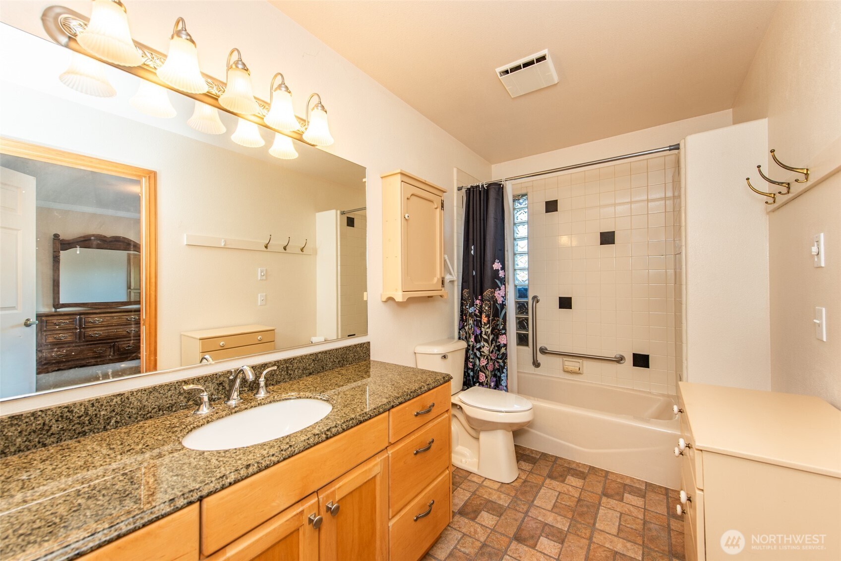 72 West Quail Lane Sequim, WA 98382 - Photo 11 of 29 a bathroom with a granite countertop sink toilet a large mirror a shower and vanity