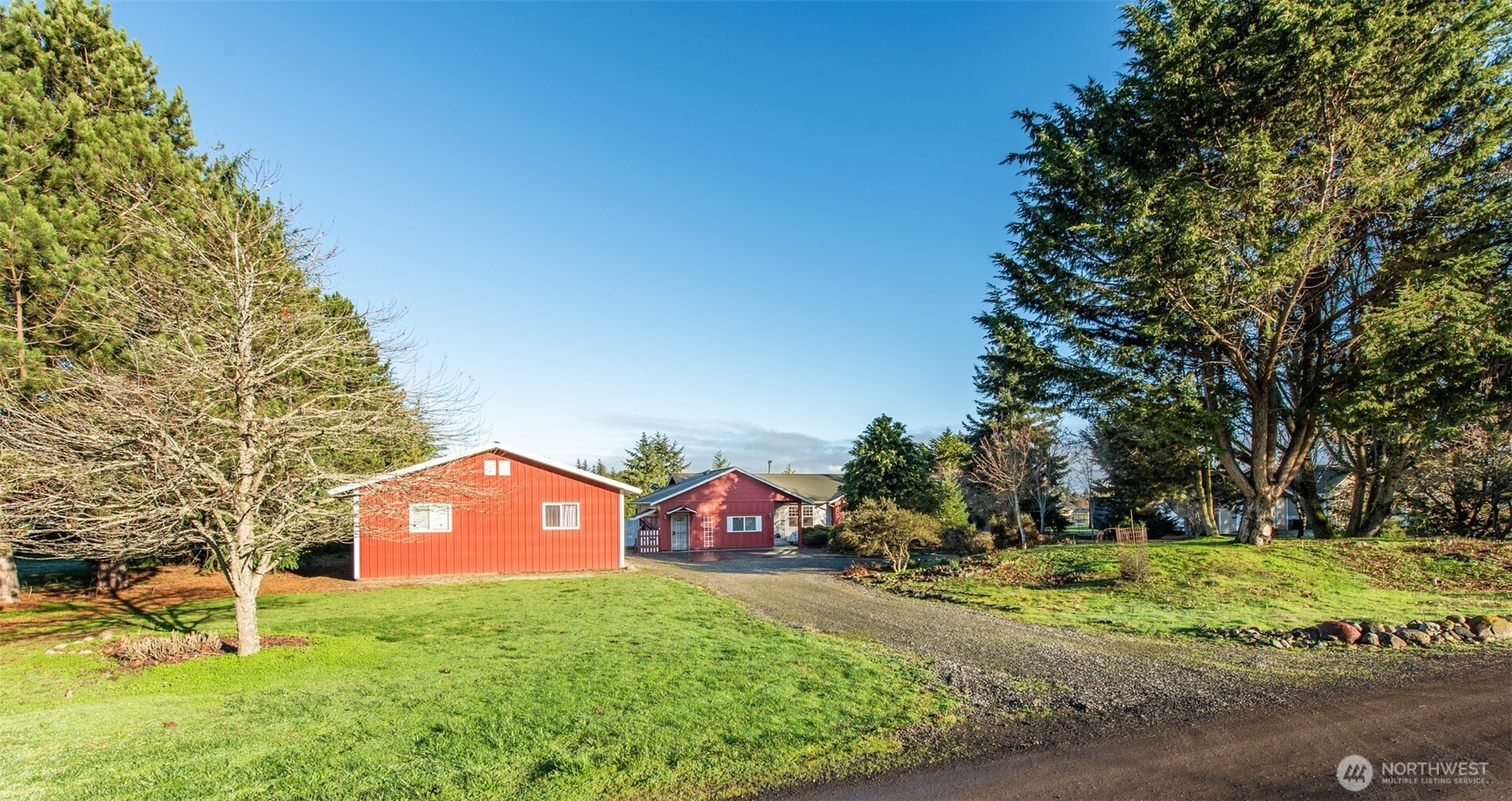 72 West Quail Lane Sequim, WA 98382 - Photo 18 of 29 a front view of a house with a yard and garage