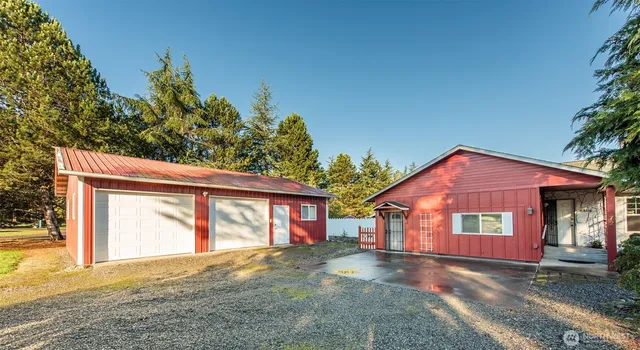 a view of a house with a yard and garage