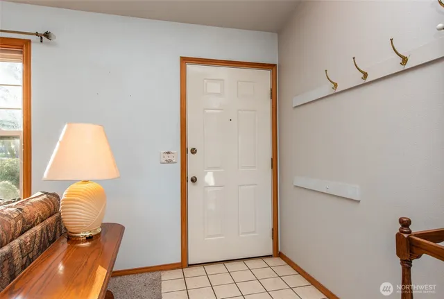 a view of an entryway with wooden floor and furniture