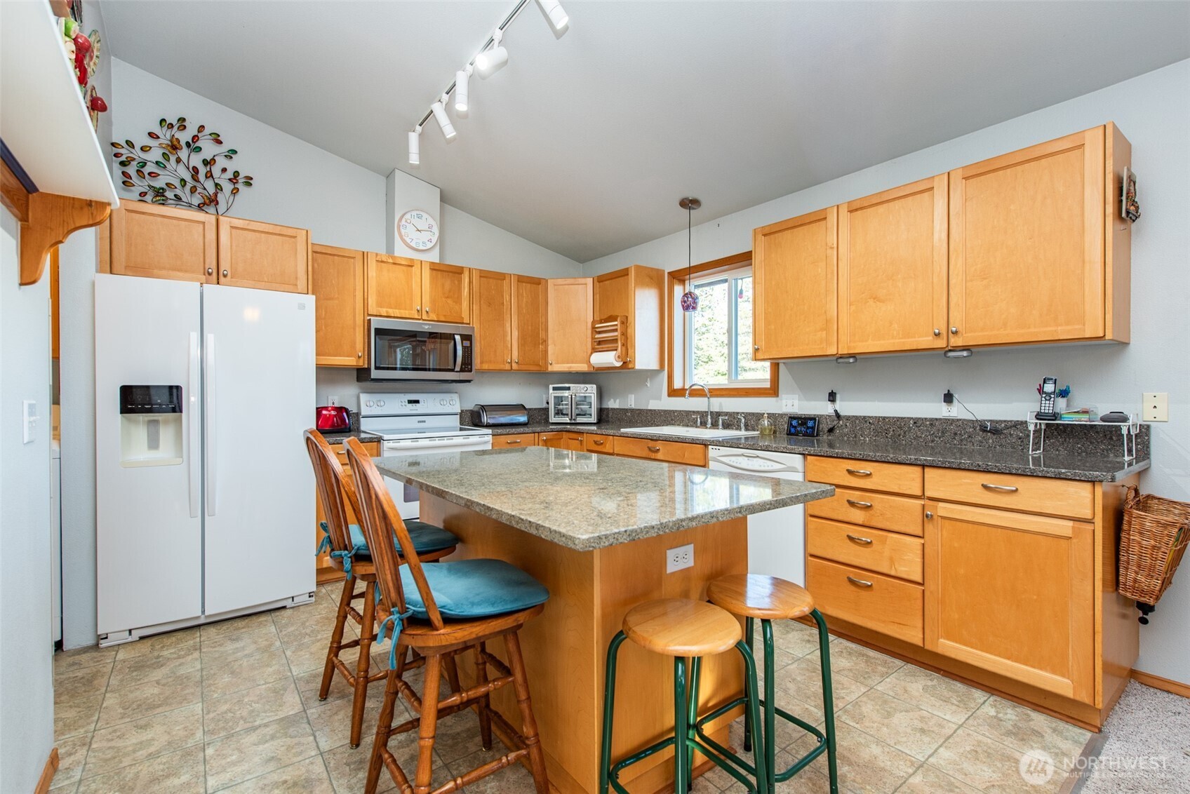 72 West Quail Lane Sequim, WA 98382 - Photo 6 of 29 a kitchen with stainless steel appliances granite countertop a table chairs sink refrigerator and cabinets