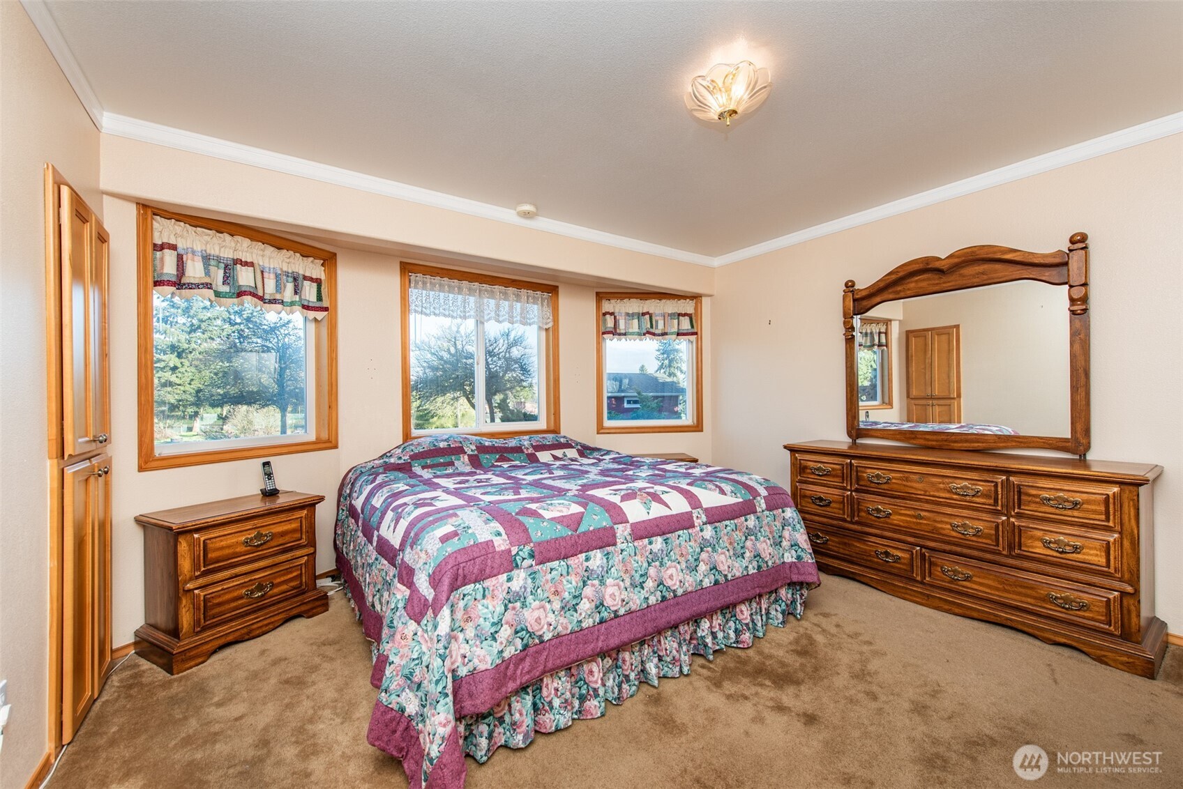 72 West Quail Lane Sequim, WA 98382 - Photo 9 of 29 a bedroom with a bed and a dresser with mirror