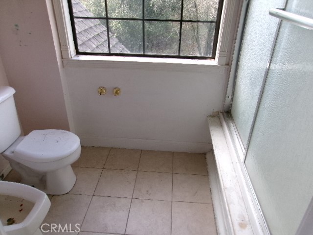 17392 Cache Creek Road Clearlake Oaks, CA 95423 - Photo 15 of 25 a bathroom with a toilet and a shower