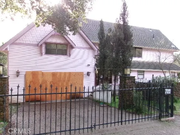 a view of a brick house with a small yard