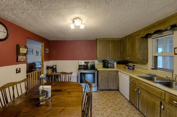 135 Fenton Road Monson, MA 01057 - Photo 7 of 30 a kitchen with lots of counter top space and dining table