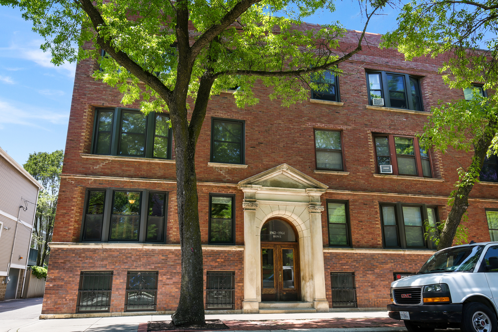 1962 North Howe Street, Unit 1 Chicago, IL 60614 - Photo 1 of 1 a front view of a residential apartment building with a yard