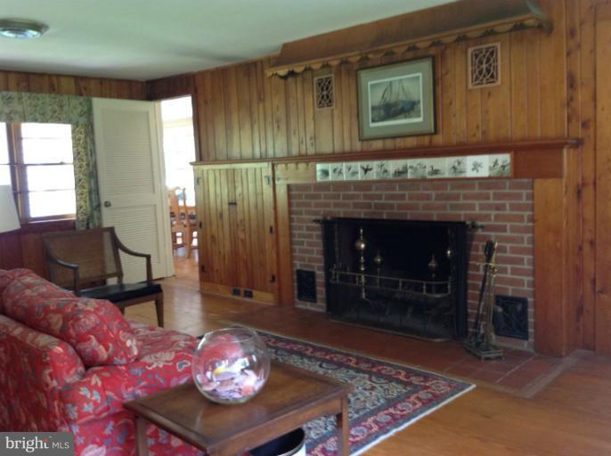 6905 Pea Neck Road St. Michaels, MD 21663 - Photo 22 of 30 a living room with furniture and a fireplace