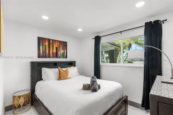 a bedroom with a bed and a window