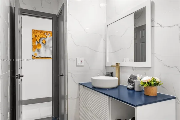 a bathroom with a sink mirror and vanity
