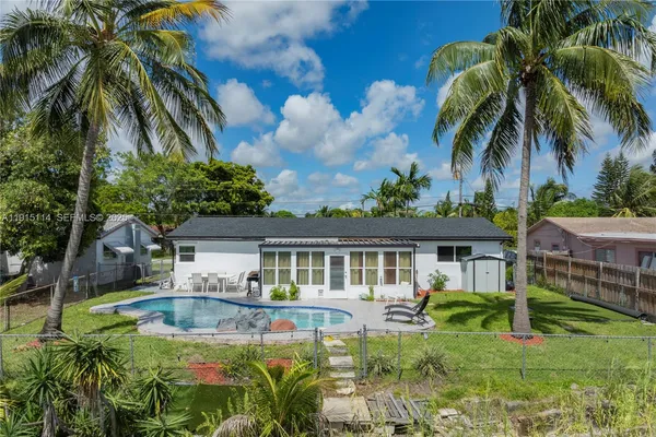 a view of a house with swimming pool and porch with furniture