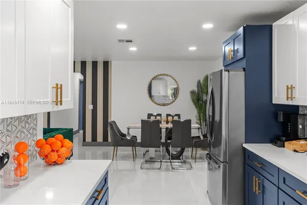 a living room with furniture a mirror and clock on the wall