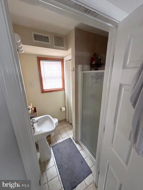 219 Connor Street Norristown, PA 19401 - Photo 17 of 38 a bathroom with a sink a toilet and shower