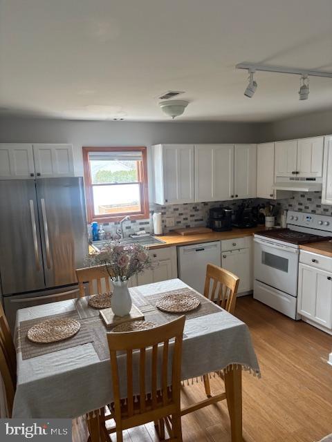 219 Connor Street Norristown, PA 19401 - Photo 8 of 38 a kitchen with stainless steel appliances granite countertop a stove a sink dishwasher a refrigerator and white cabinets with wooden floor
