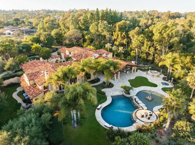 an aerial view of a house with yard swimming pool and outdoor seating