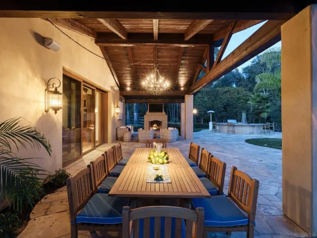a living room with furniture a fireplace and a garden