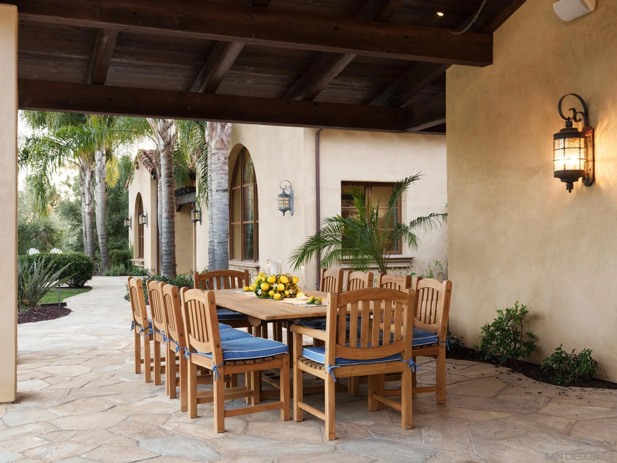 16409 Via De Santa Fe Rancho Santa Fe, CA 92067 - Photo 39 of 41 a view of a patio with a table and chairs next to a yard