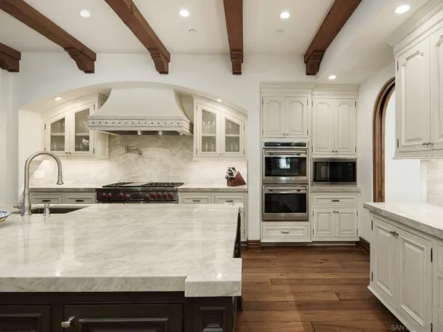 a kitchen with stainless steel appliances granite countertop a stove and a sink